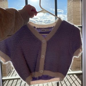 A fluffy purple and white button up(cropped).